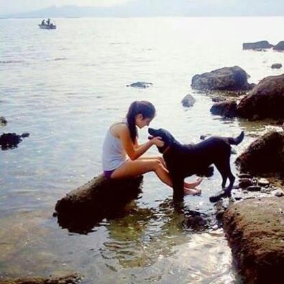 Mi hija Marta con Nana en la playa a la que van los perros
